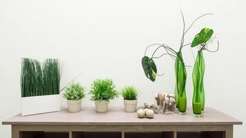 A table with various potted plants and decorative items.