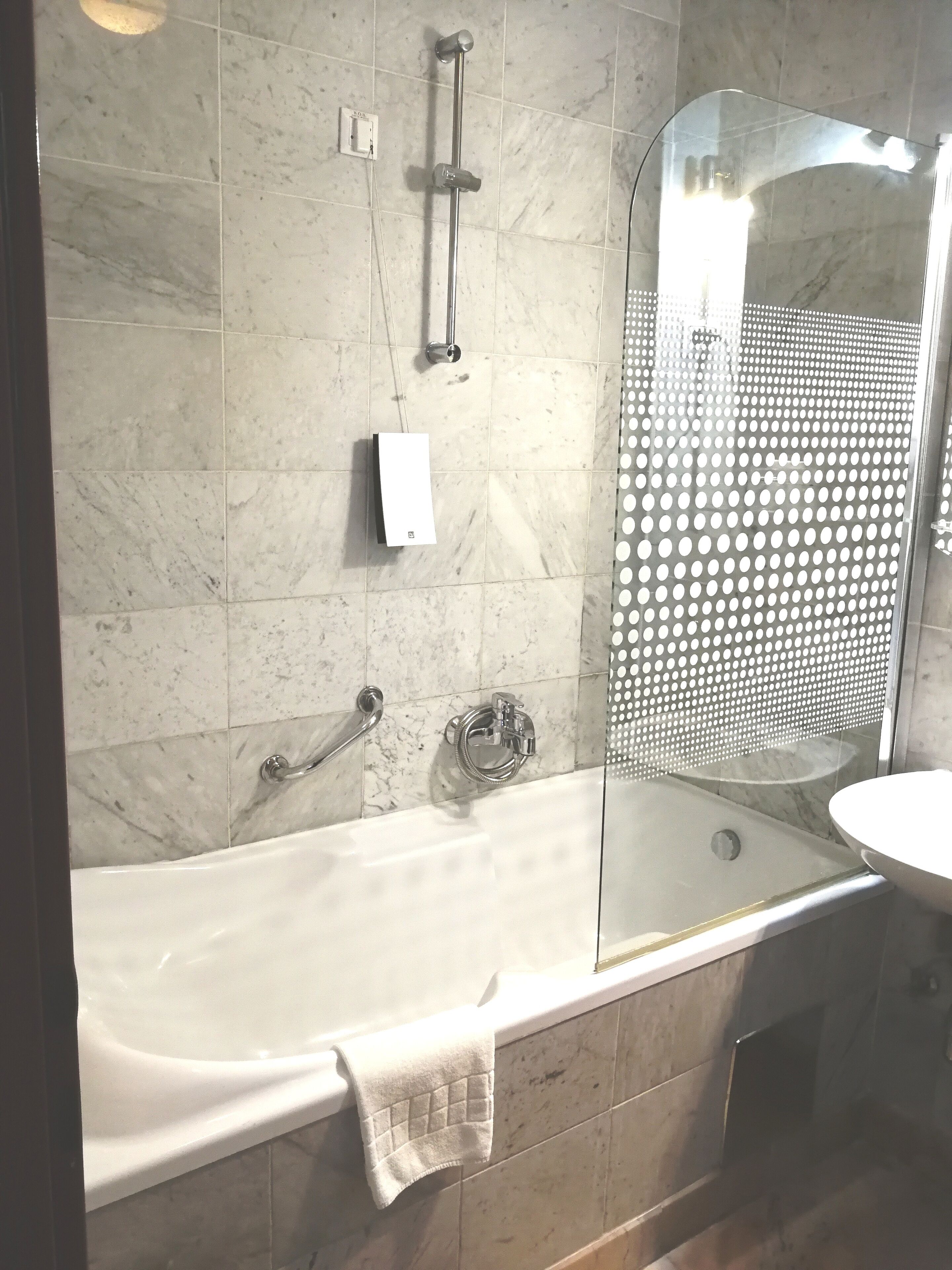 A bathroom with a bathtub, a shower, and a sink.