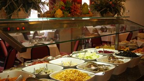 A buffet with various food items and utensils. - Hotel Caribe (Rota)