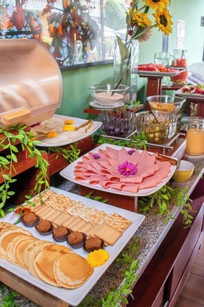 A buffet with various food items including pancakes, pastries, and a variety of spreads. - Casa de Avila Hotel (Arequipa)