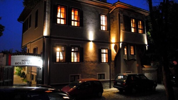 A two-story building with illuminated windows and a sign for 'Hotel Bellagio Villa'. - Belle Ville (Plovdiv)