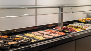 A buffet with various food items including meats, cheeses, and fruits. - Naitly Barcelona Poblenou (Barcelona)