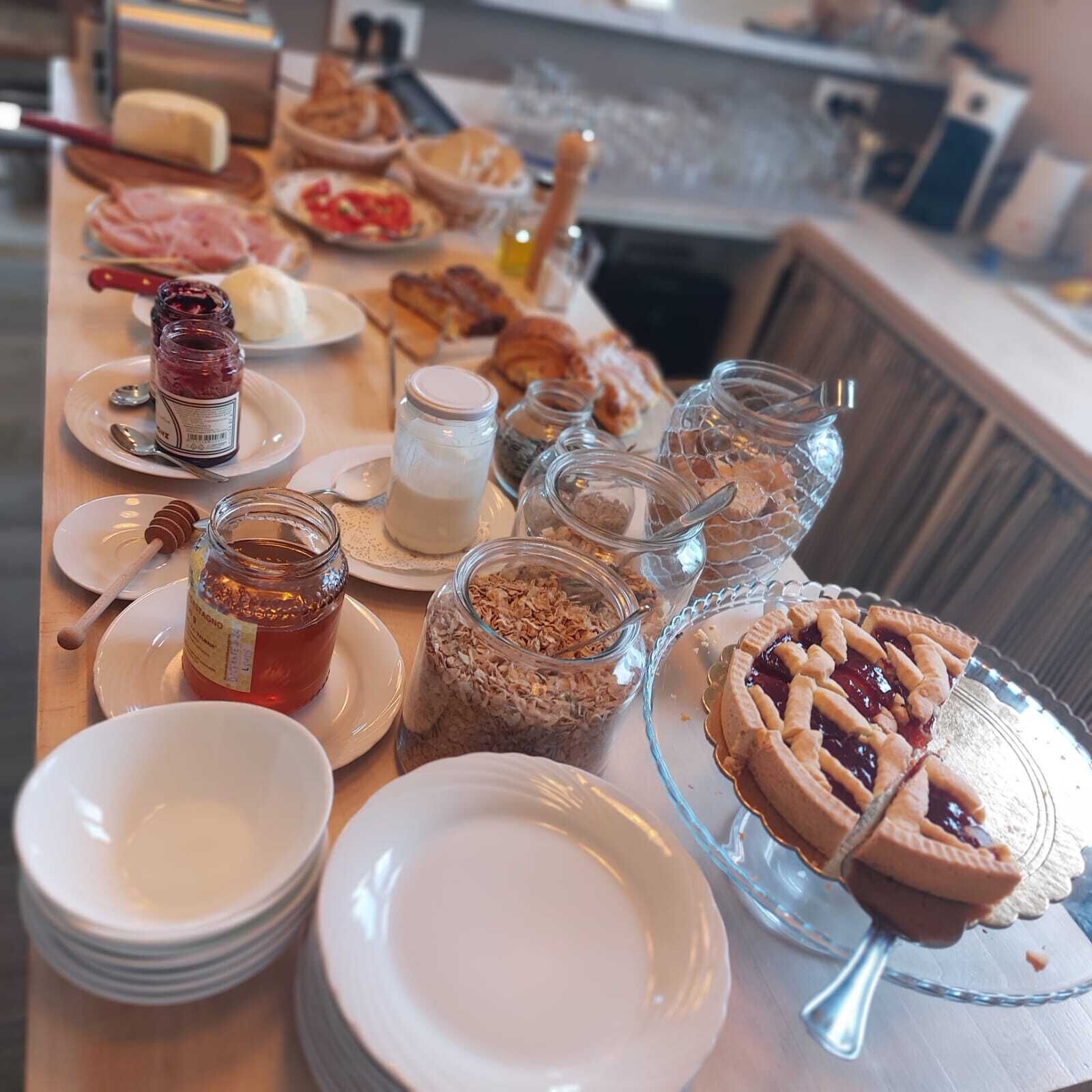 A breakfast buffet with various food items and condiments.