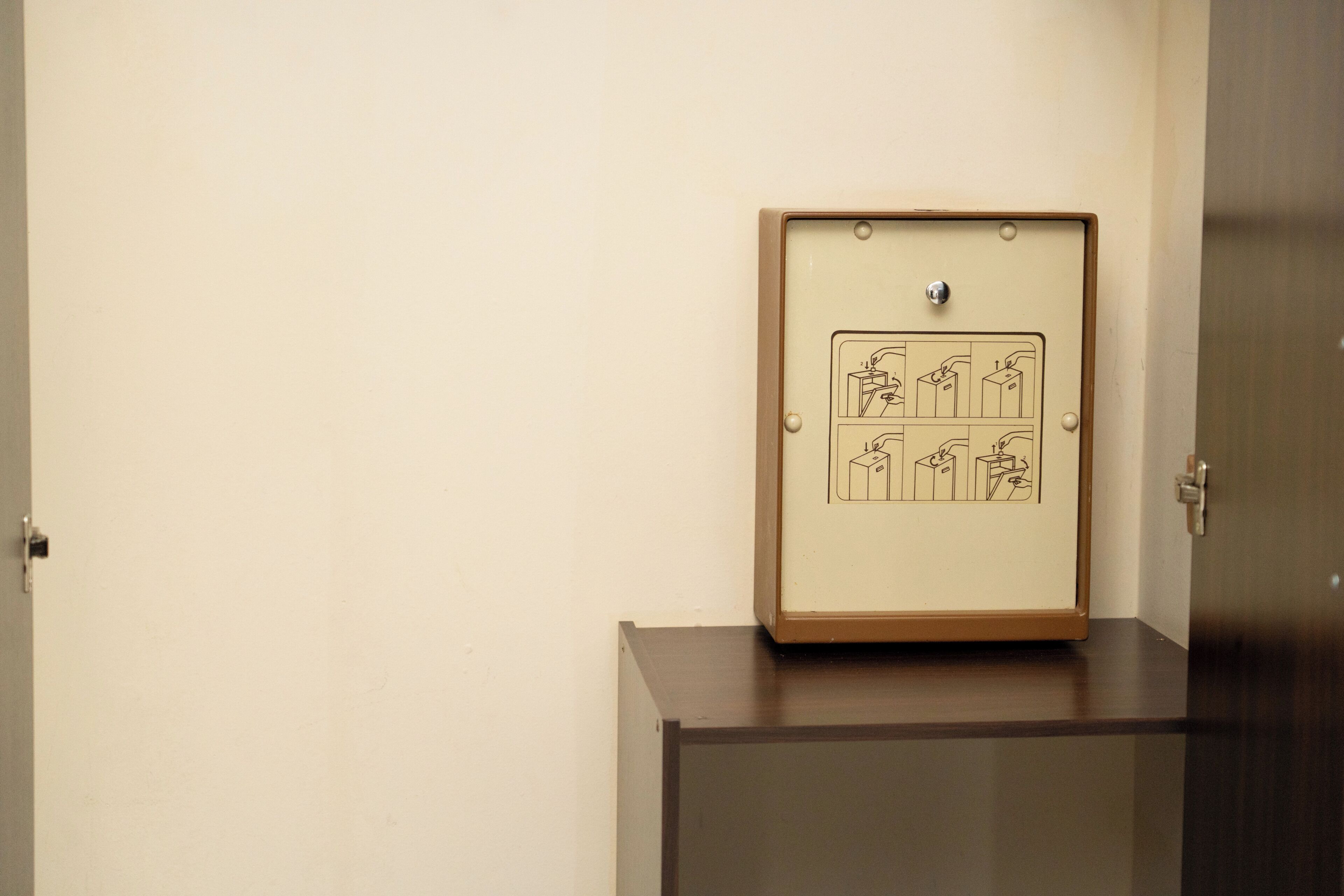 A framed diagram on a cabinet with a door in the background.