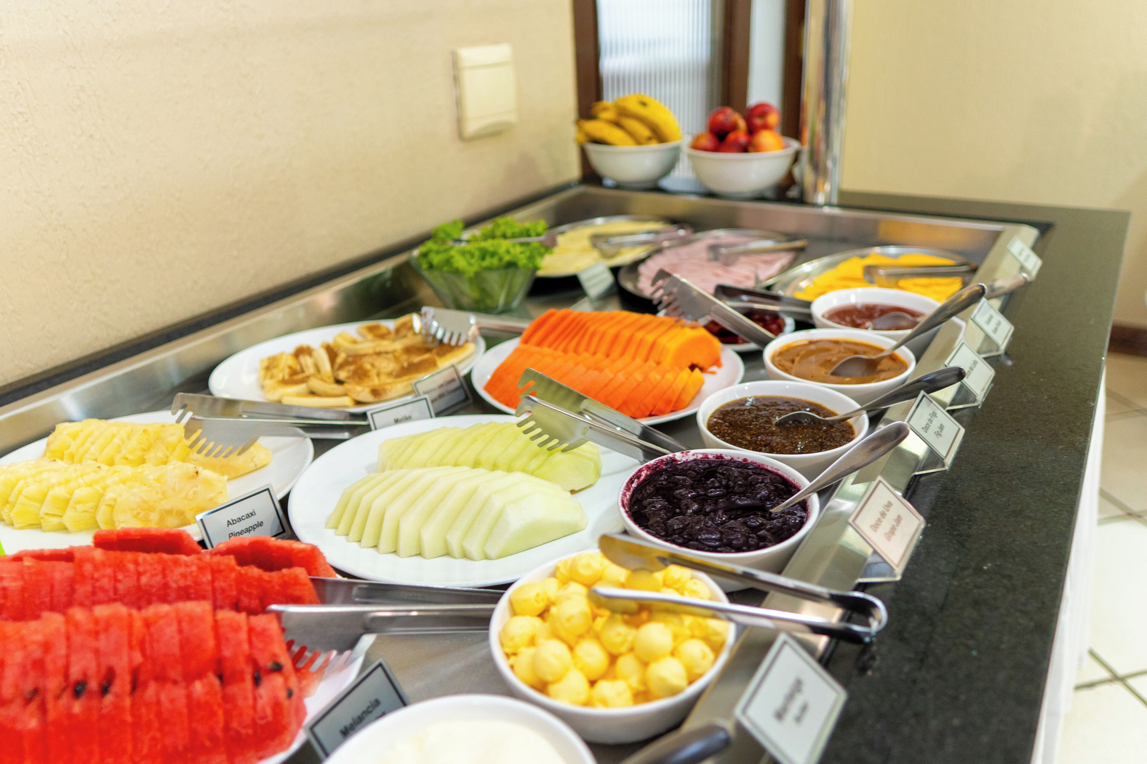 A buffet with various fruits and dishes.