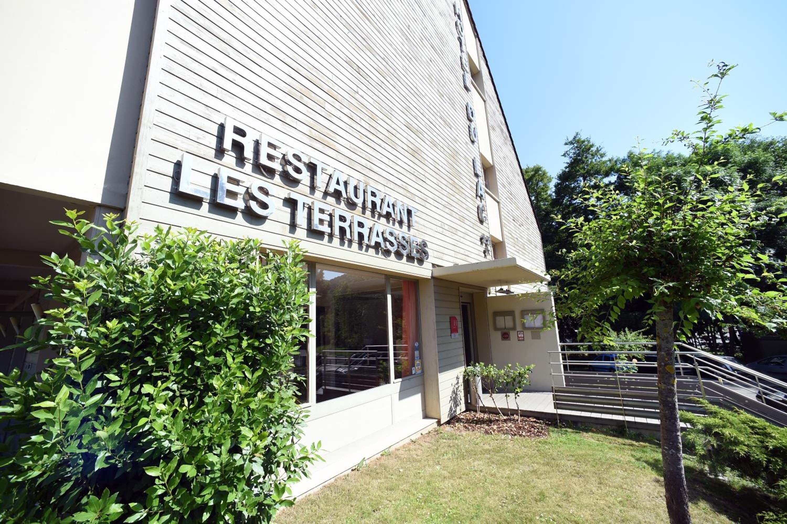 Een gebouw met een bord waarop staat 'RESTAURANT LES TERRASSES'.