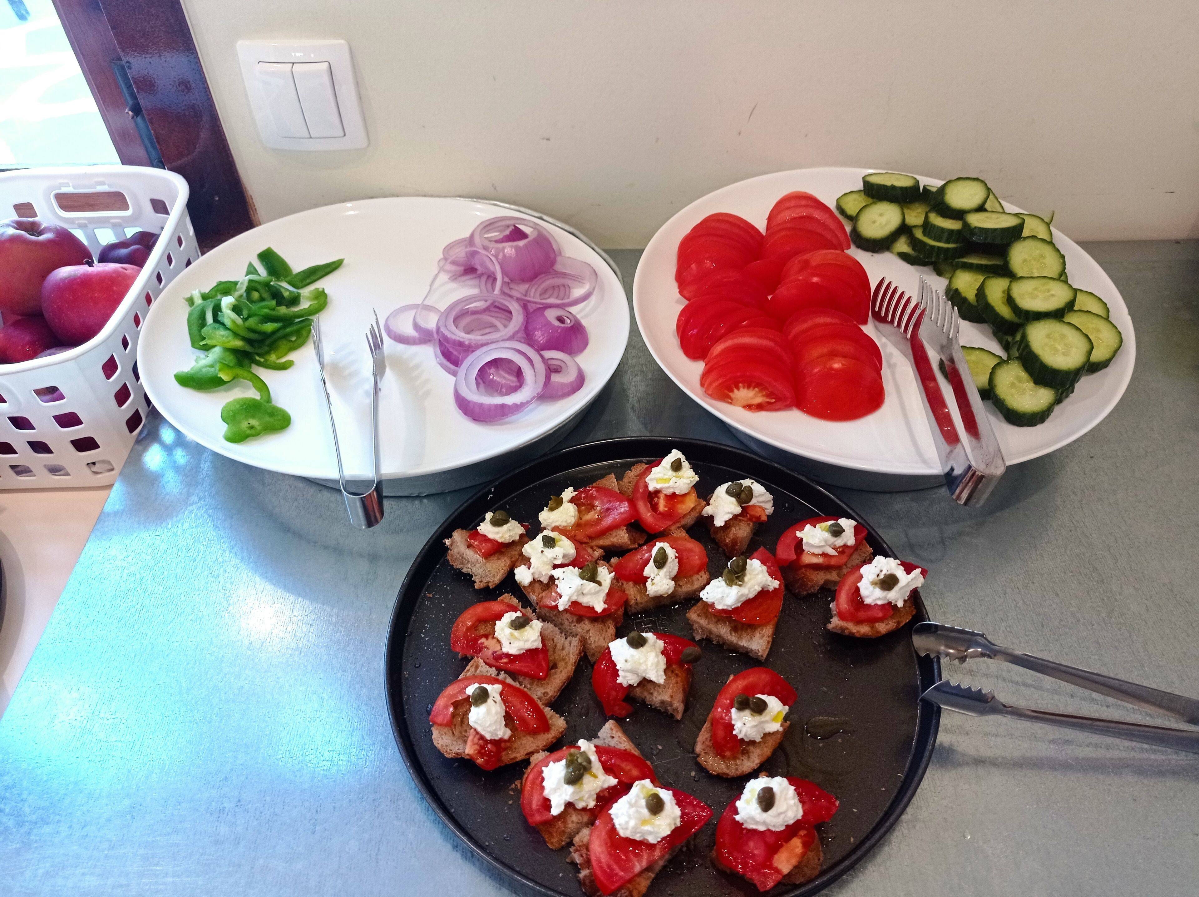 A kitchen counter with various food items and utensils.