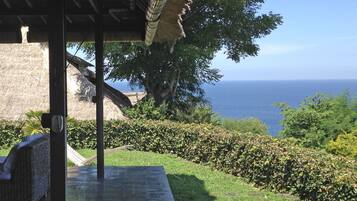 A covered outdoor area with a view of the sea.