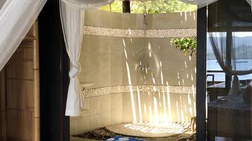 Enjoy a peaceful retreat with a neatly made bed, large window, and serene view.