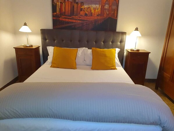 Desk, laptop workspace, blackout drapes, iron/ironing board