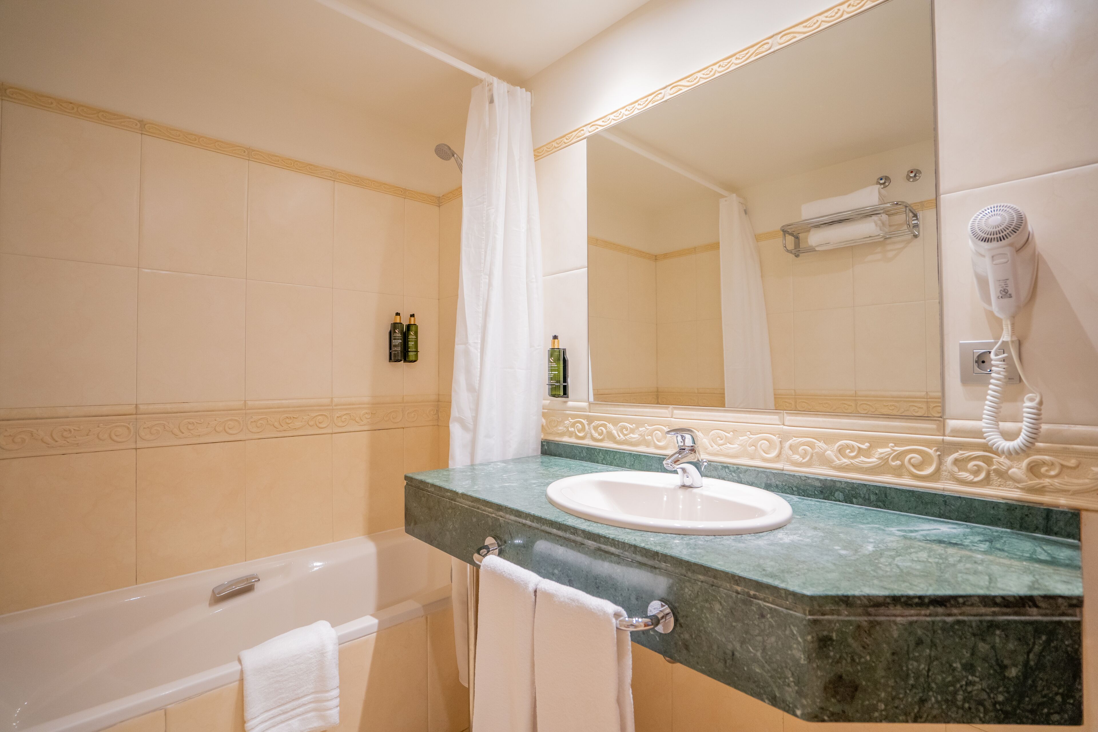 junior suite | bathroom | bathtub, hair dryer, towels
