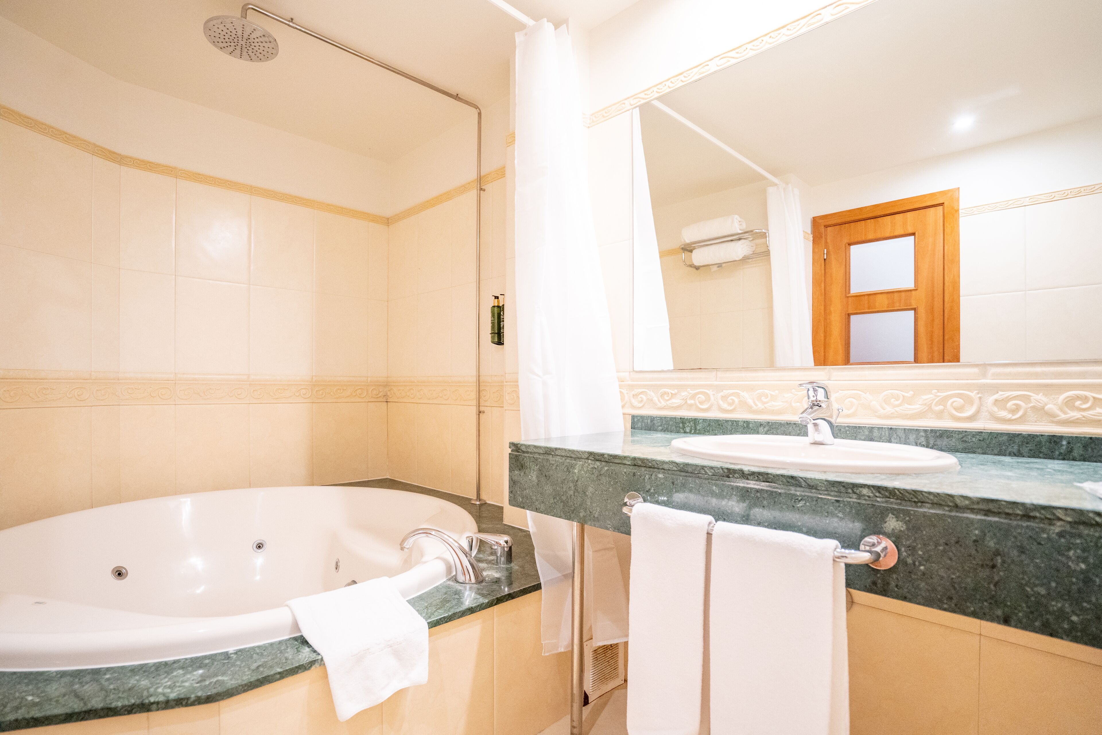 A bathroom with a bathtub, a sink, and a shower.