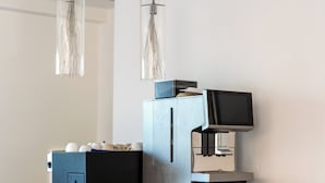 A coffee machine with a digital display, a coffee grinder, and a cup holder on a counter. - La Rosa dei Venti (Portopalo di Capo Passero)