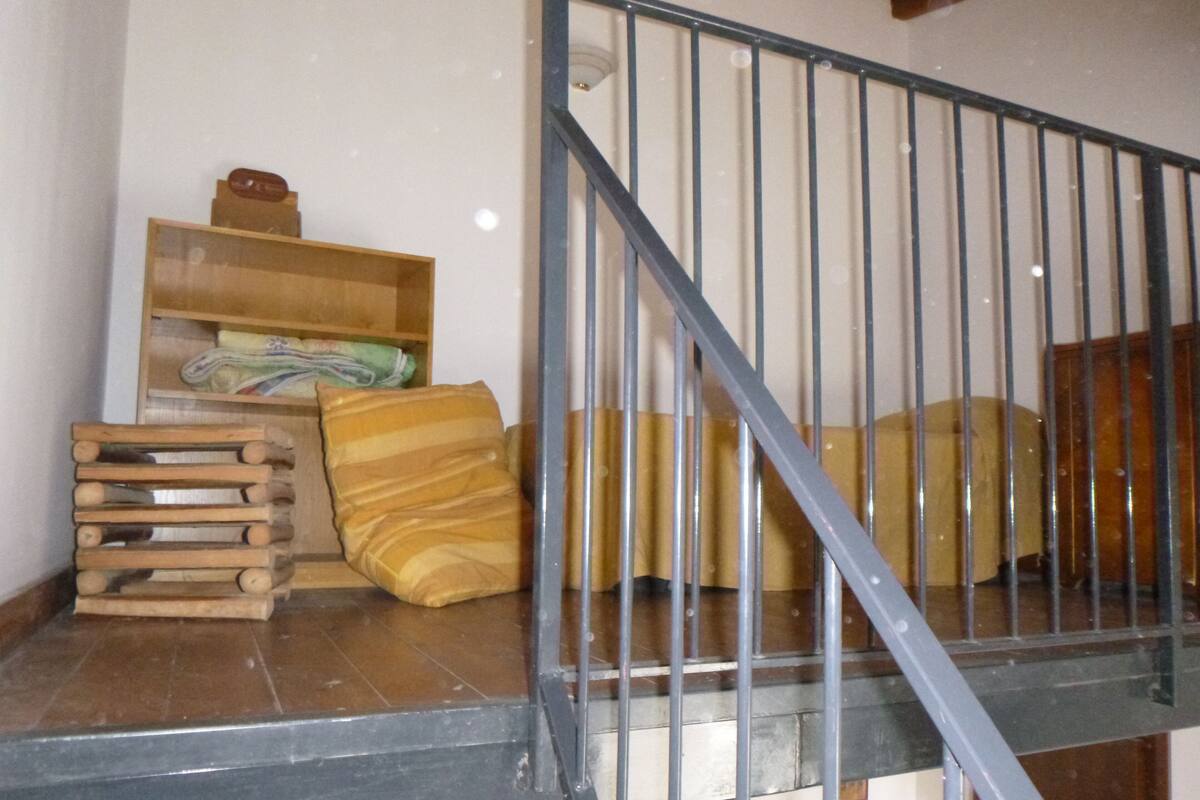 A staircase with metal railings leading to a landing area.