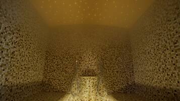 Unique mosaic wall design and central illuminated feature create a warm ambiance in this stylish space.