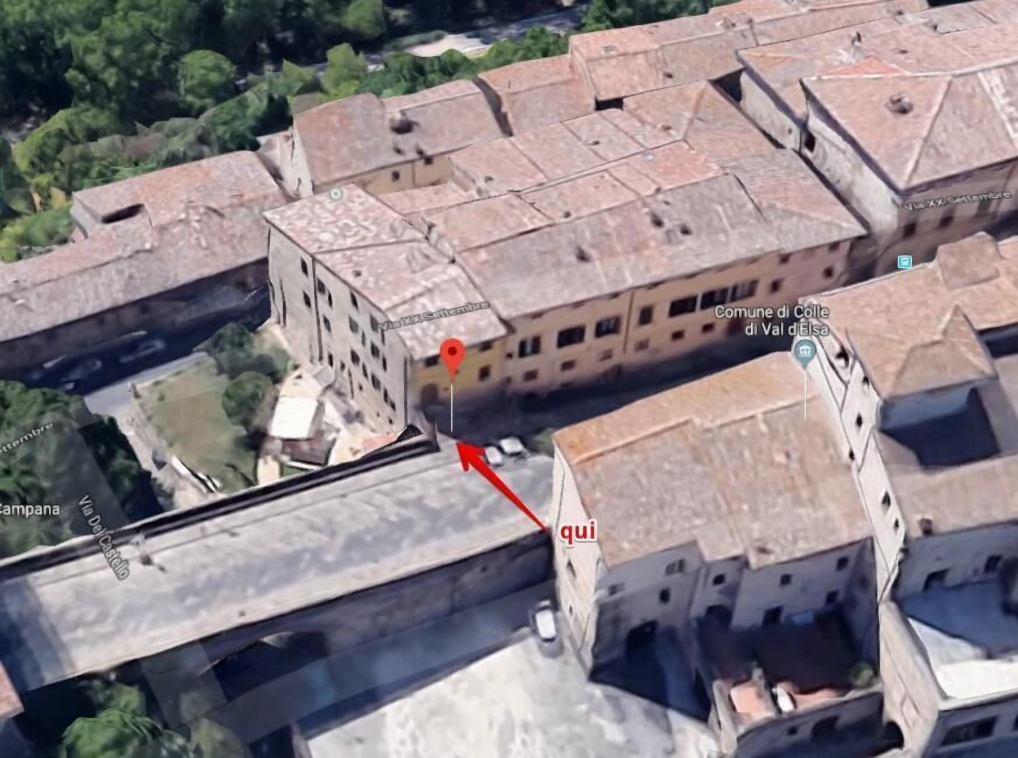 An aerial view of a historic town with narrow streets and traditional buildings.