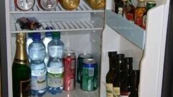 An open refrigerator with various beverages and bottles.