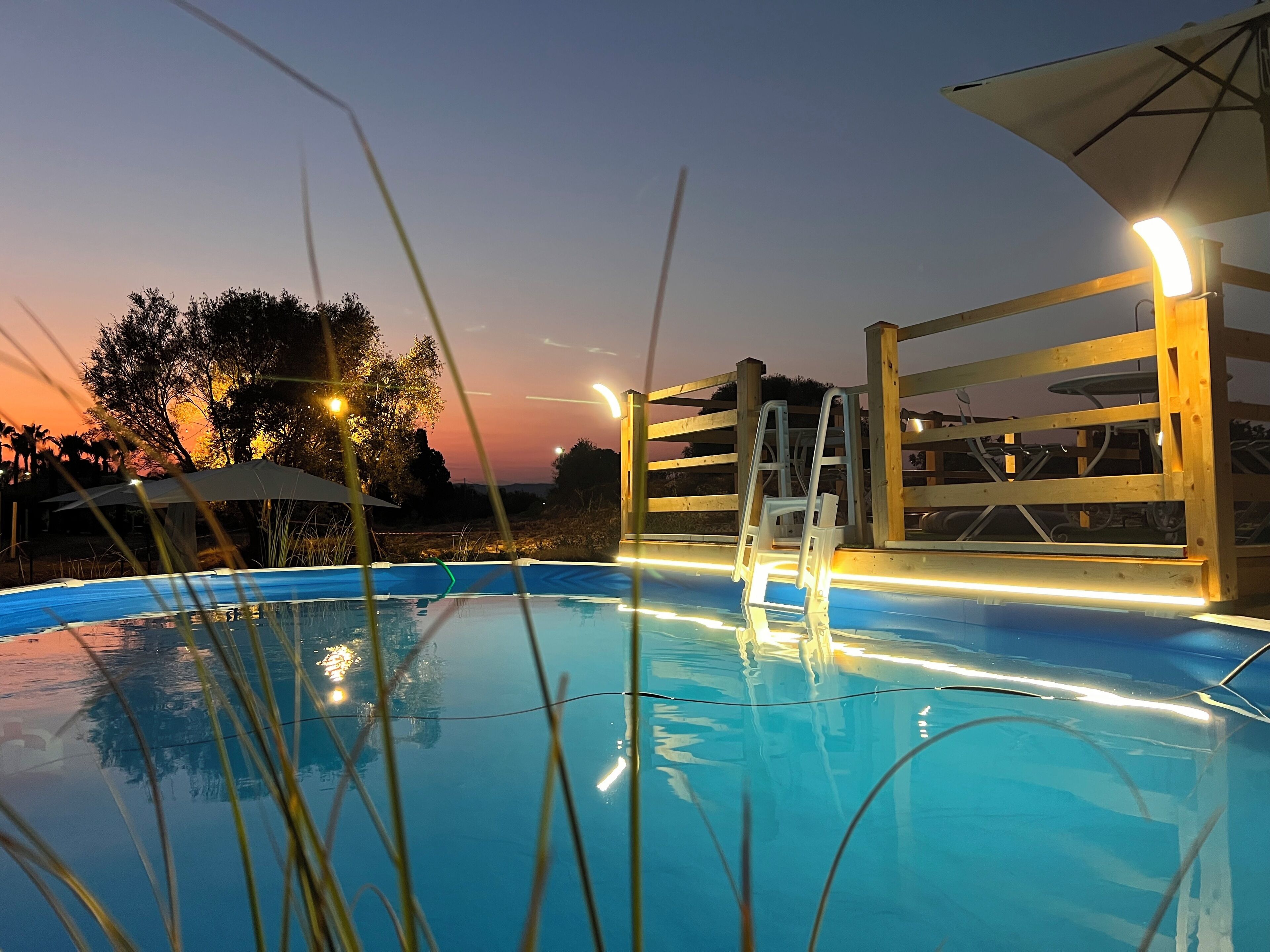 Seasonal outdoor pool, open 9:00 AM to 7:00 PM, pool umbrellas