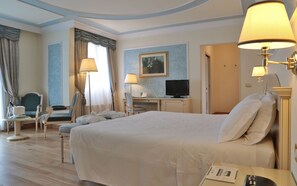 A hotel room with a large bed, two chairs, a desk with a computer, and a television. - Hotel Terme Imperial (Montegrotto Terme)