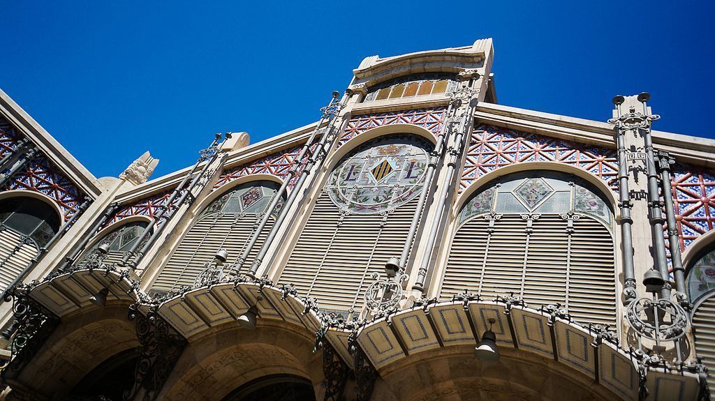 A building with ornate architectural details, including arched windows and decorative metalwork.