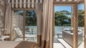 A hotel room with a balcony, a dining area, and a view of the outdoors. - Villa Madruzzo (Trento)
