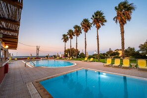 Seasonal outdoor pool, open 9:00 AM to 7:30 PM, pool umbrellas