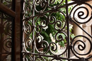 A wrought iron gate with intricate scrollwork.
