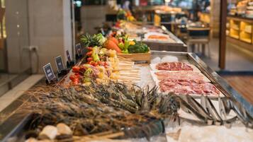 A seafood display with various types of seafood including shrimp, squid, and fish, arranged on ice in a restaurant setting.