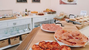 A buffet setup with various food items including pastries, meats, and condiments. - Hotel Rodeiramar (Cangas)