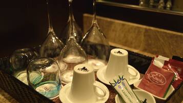 A tray with tea bags, a creamer, and glasses on a table.