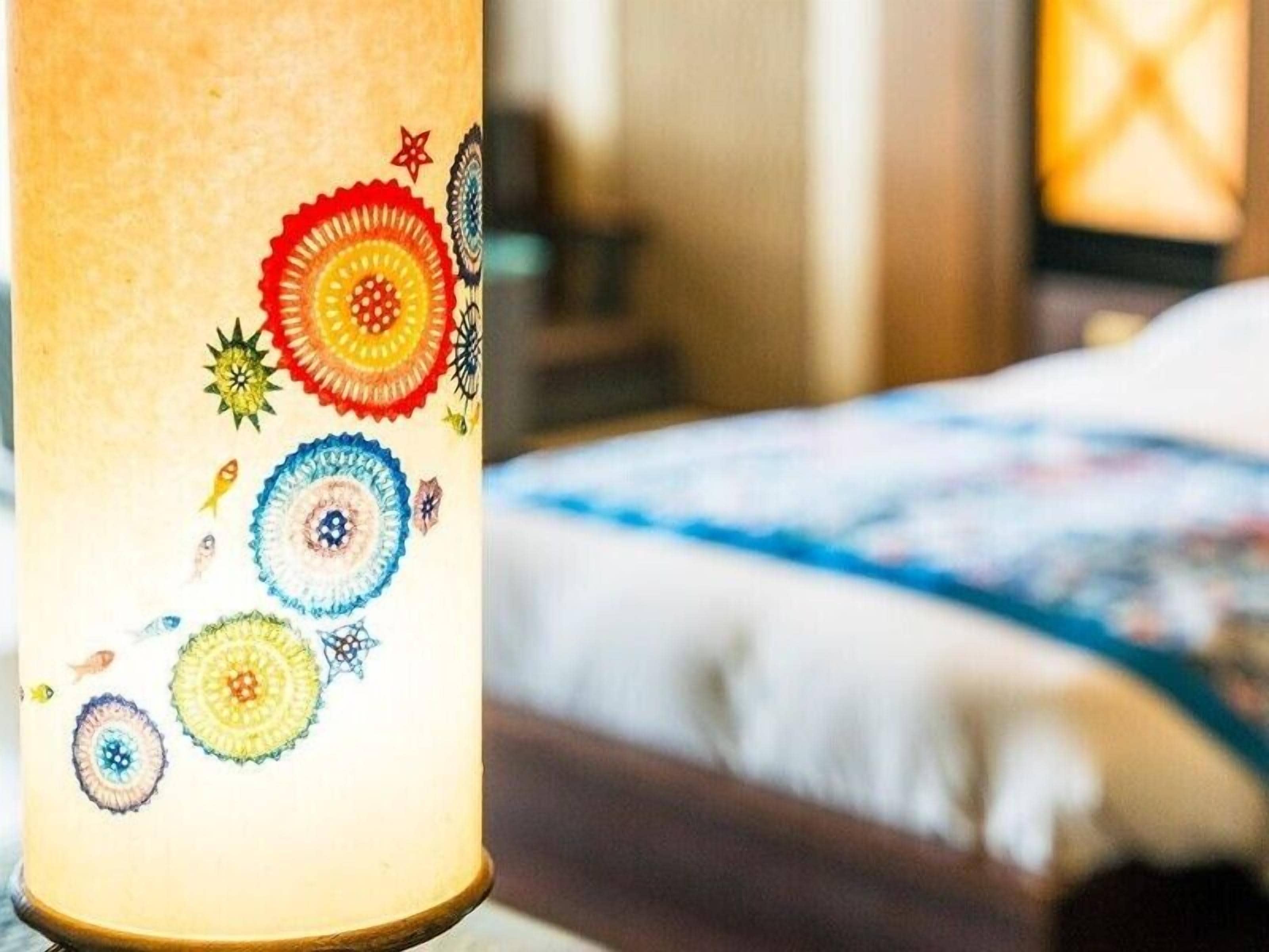 A close-up of a decorative lamp with colorful, circular patterns.