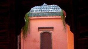 An entrance with a wooden door, a small window, and a metal railing. - Riad Aderbaz (Marrakech)