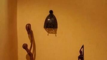 Een kamer met een houten sculptuur, een decoratieve lantaarn en een kamerbreed tapijt.