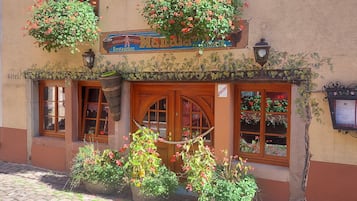 A building with a sign reading "Manala Restaurant" and a "Hotel" sign below it.