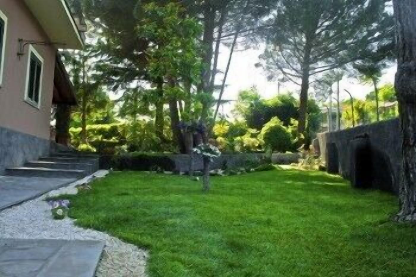 Ein gepflegter Garten mit einem Kiesweg, der zu einem Haus führt.