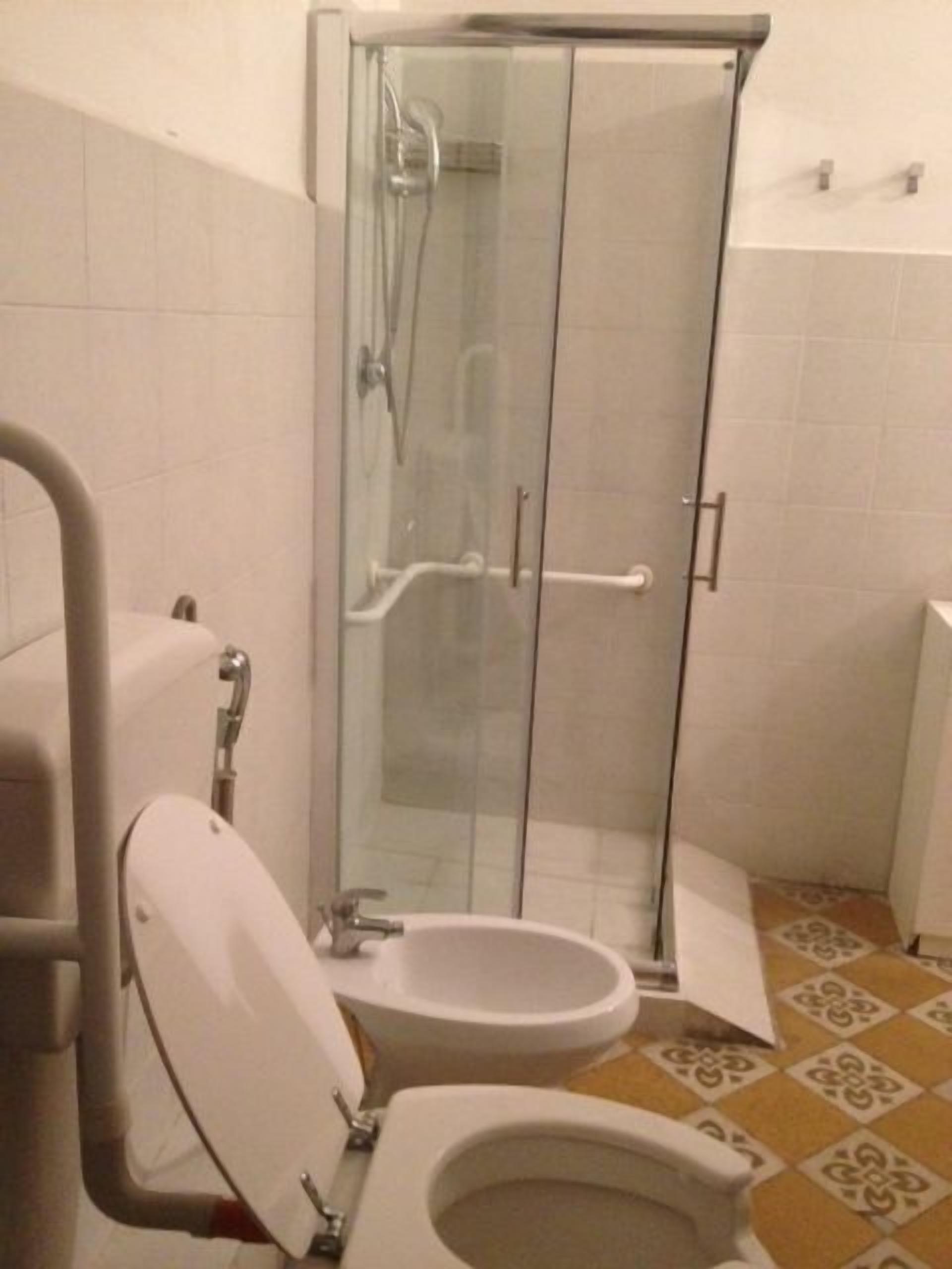 Un baño con ducha de vidrio, inodoro y bidé.