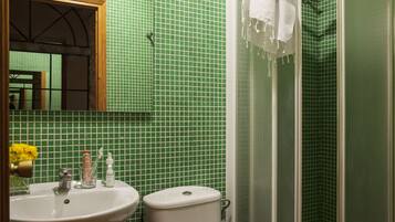 A bathroom with a sink, toilet, and shower.