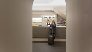 A reception area with a counter, a seating area, and a visible staircase. - Hotel Helvetia (Genoa)