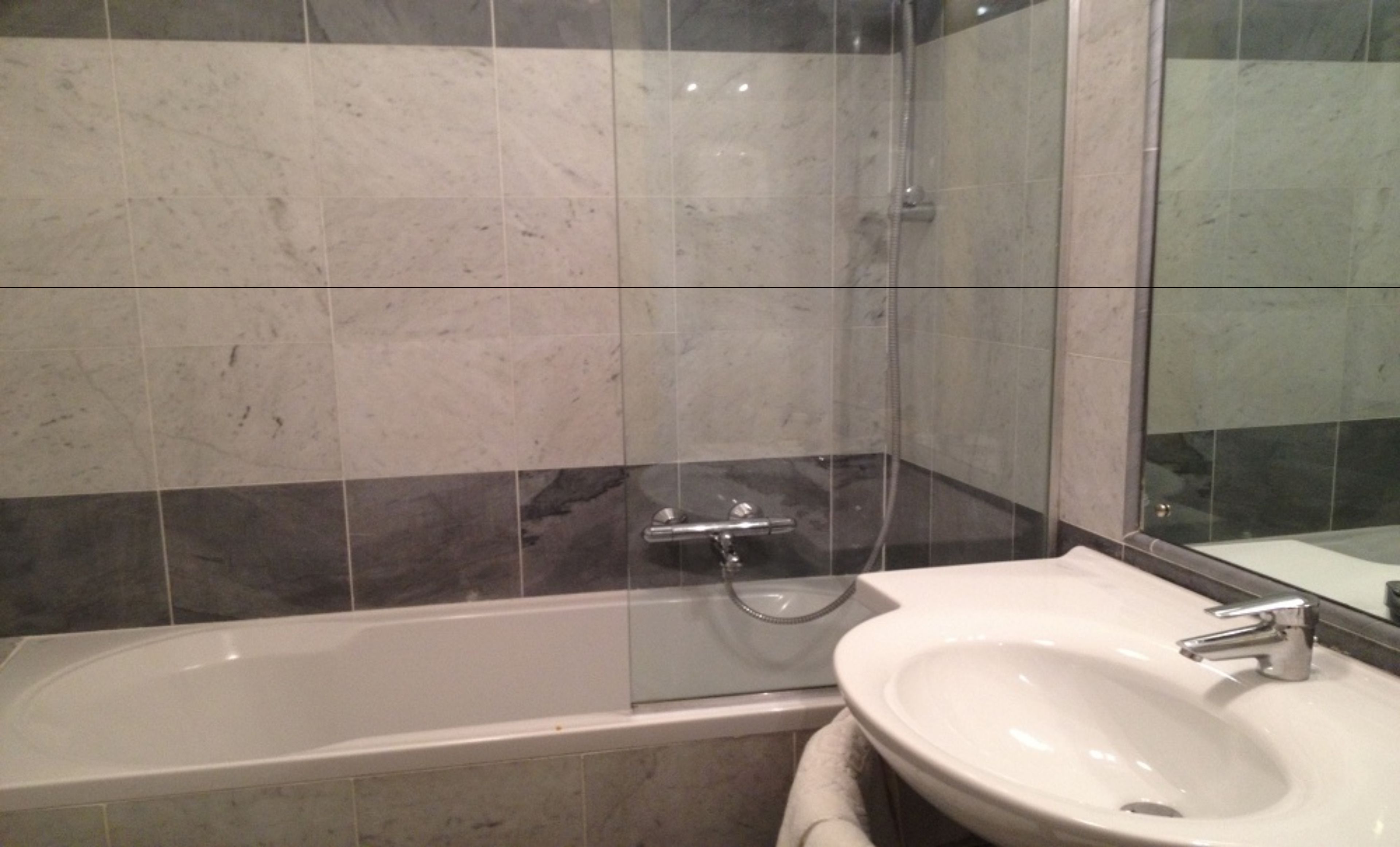 shower, hair dryer, slippers, towels