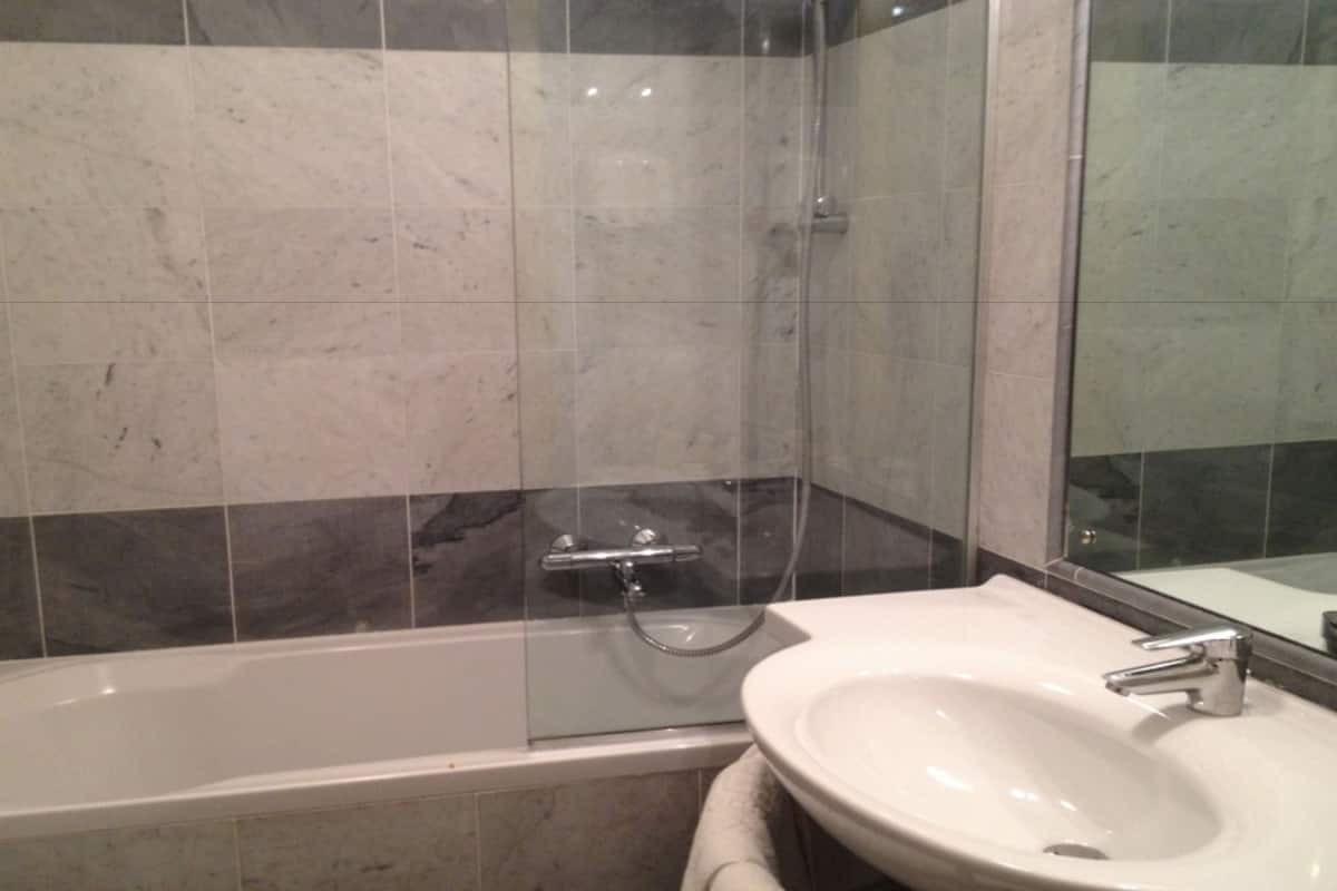 Shower, hair dryer, slippers, towels