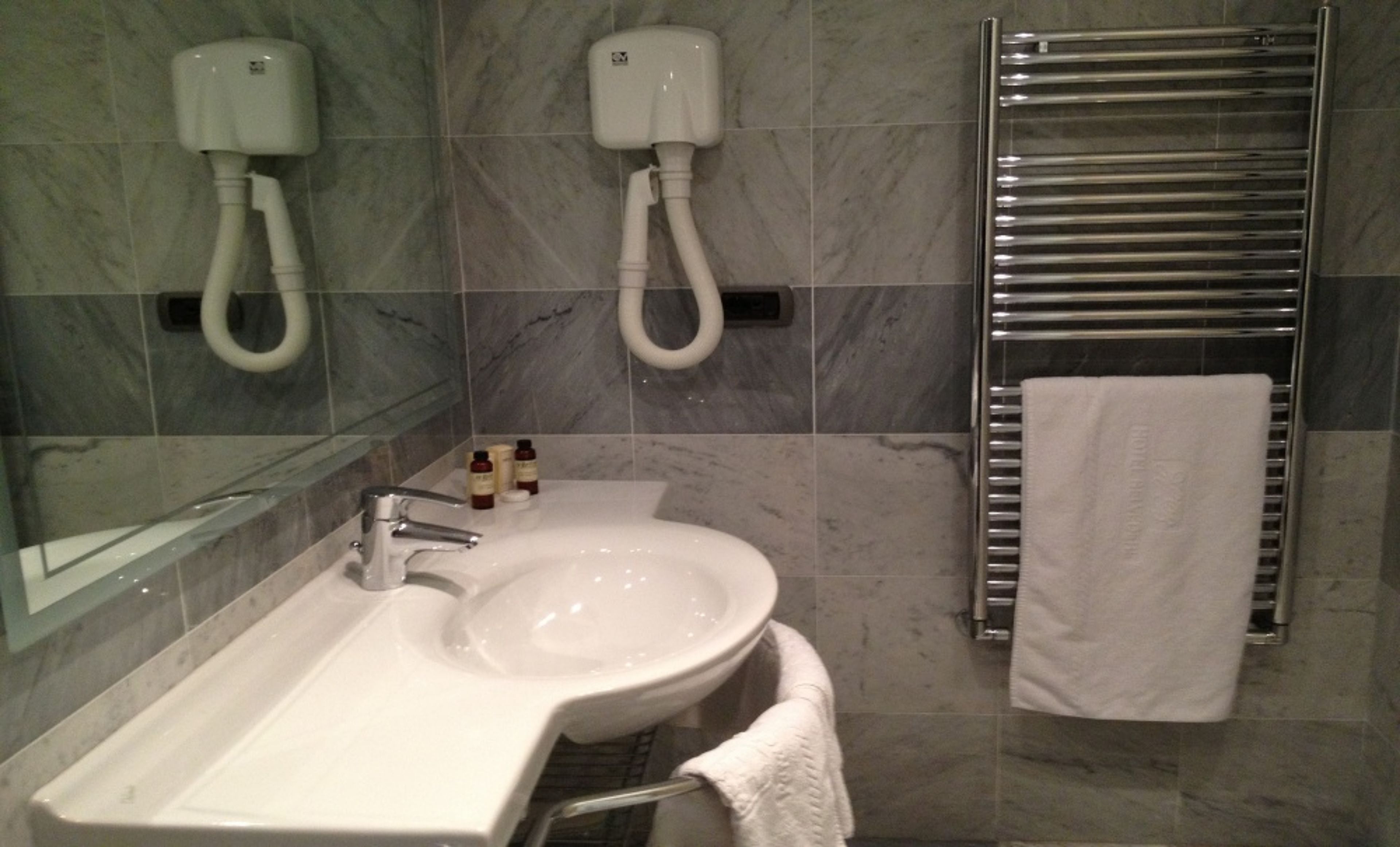 shower, hair dryer, slippers, towels