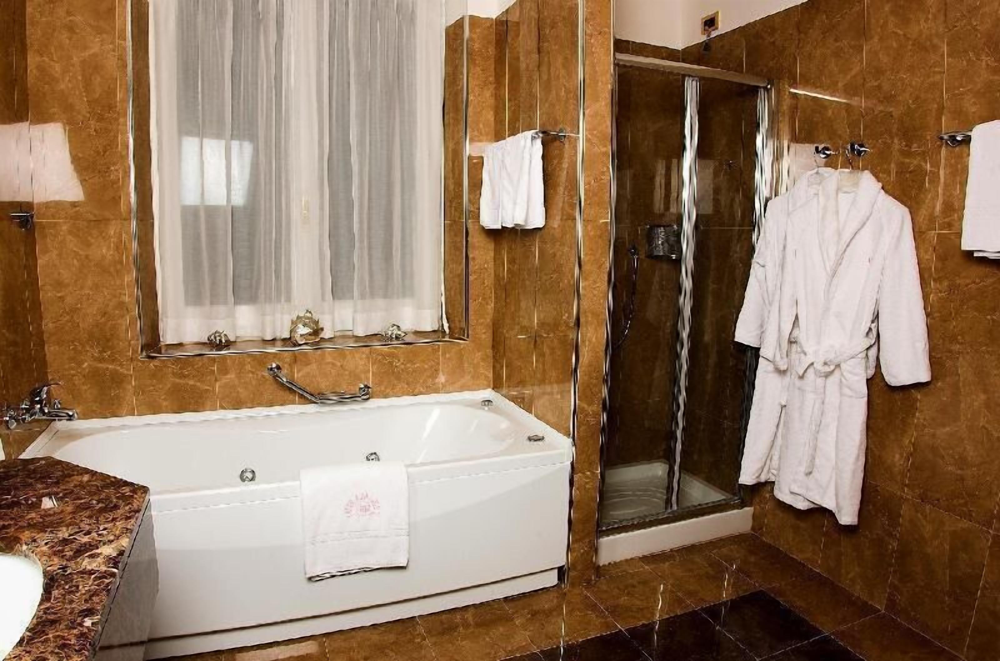 Badkamer | Een haardroger, pantoffels, een bidet, handdoeken