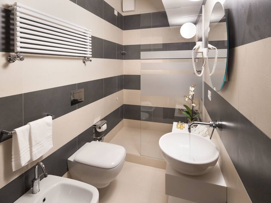 A modern bathroom with a bathtub, a sink, and a toilet.
