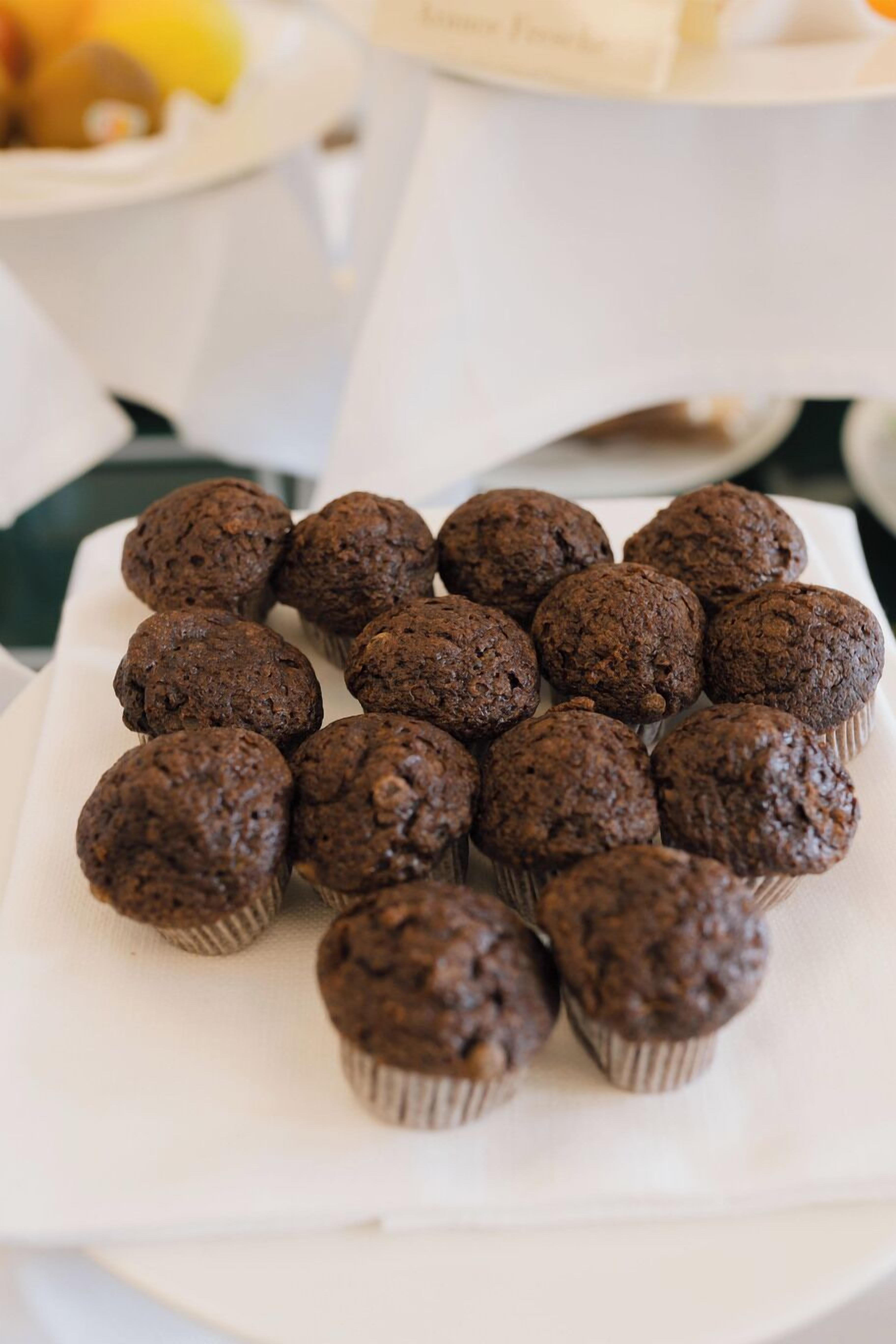 A tray of chocolate muffins on a white plate.