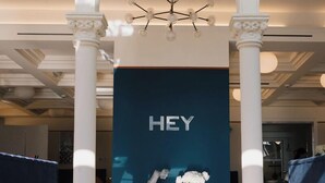 A modern hotel lobby with a 'HEY' sign, white columns, a chandelier, and a blue accent wall. - SPLENDIDE RIVIERA   (Rapallo)