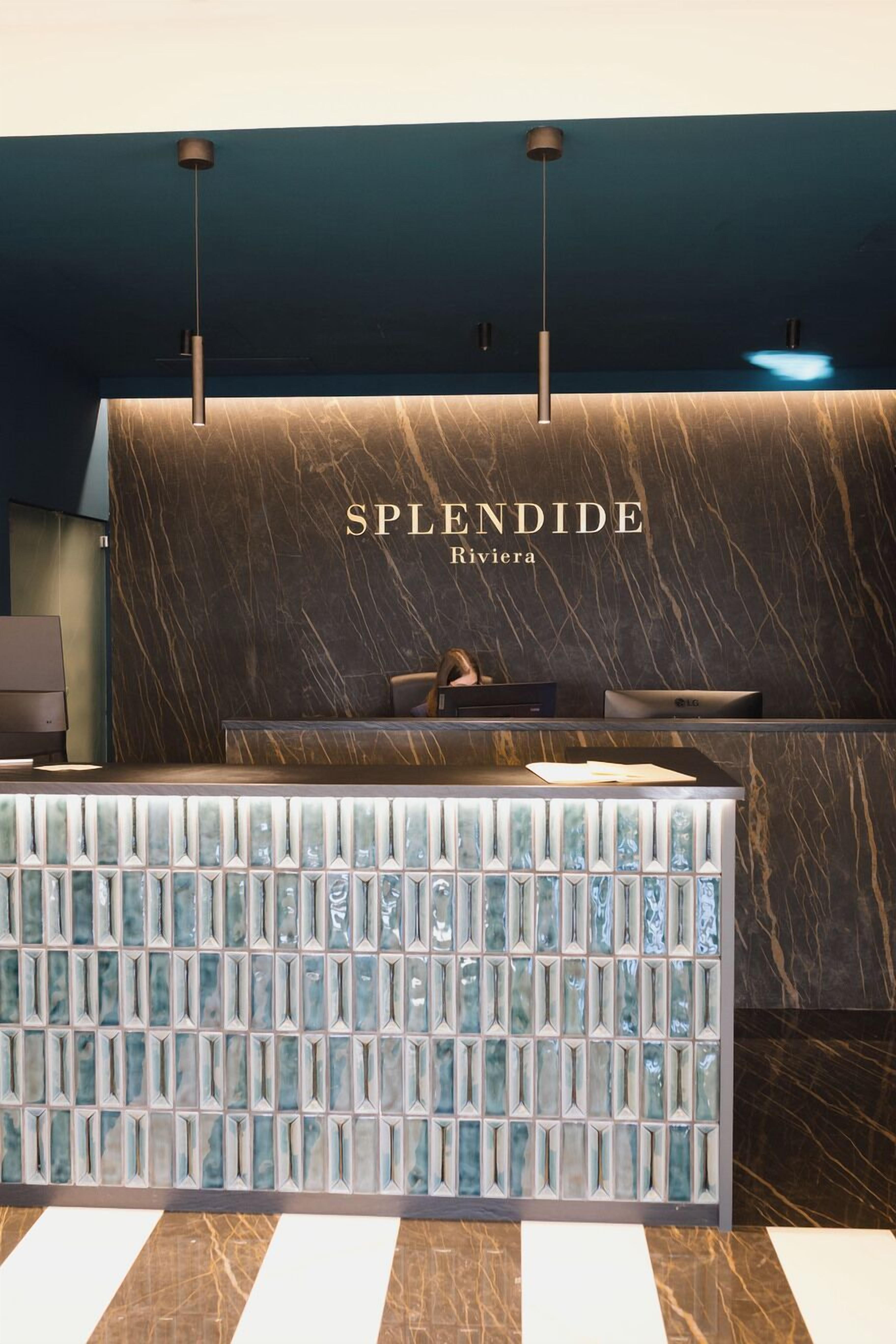 A reception desk with a marble top and a glass partition.