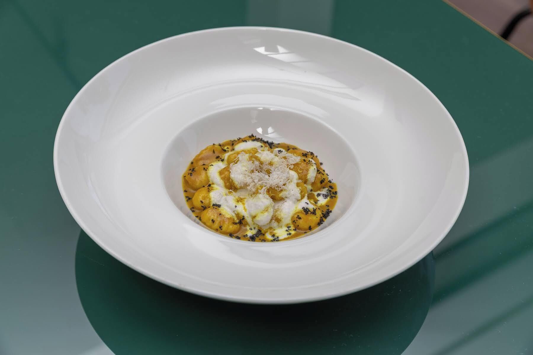 A white bowl on a green table.