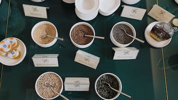 A variety of nuts and seeds displayed in bowls with labels, arranged on a table.