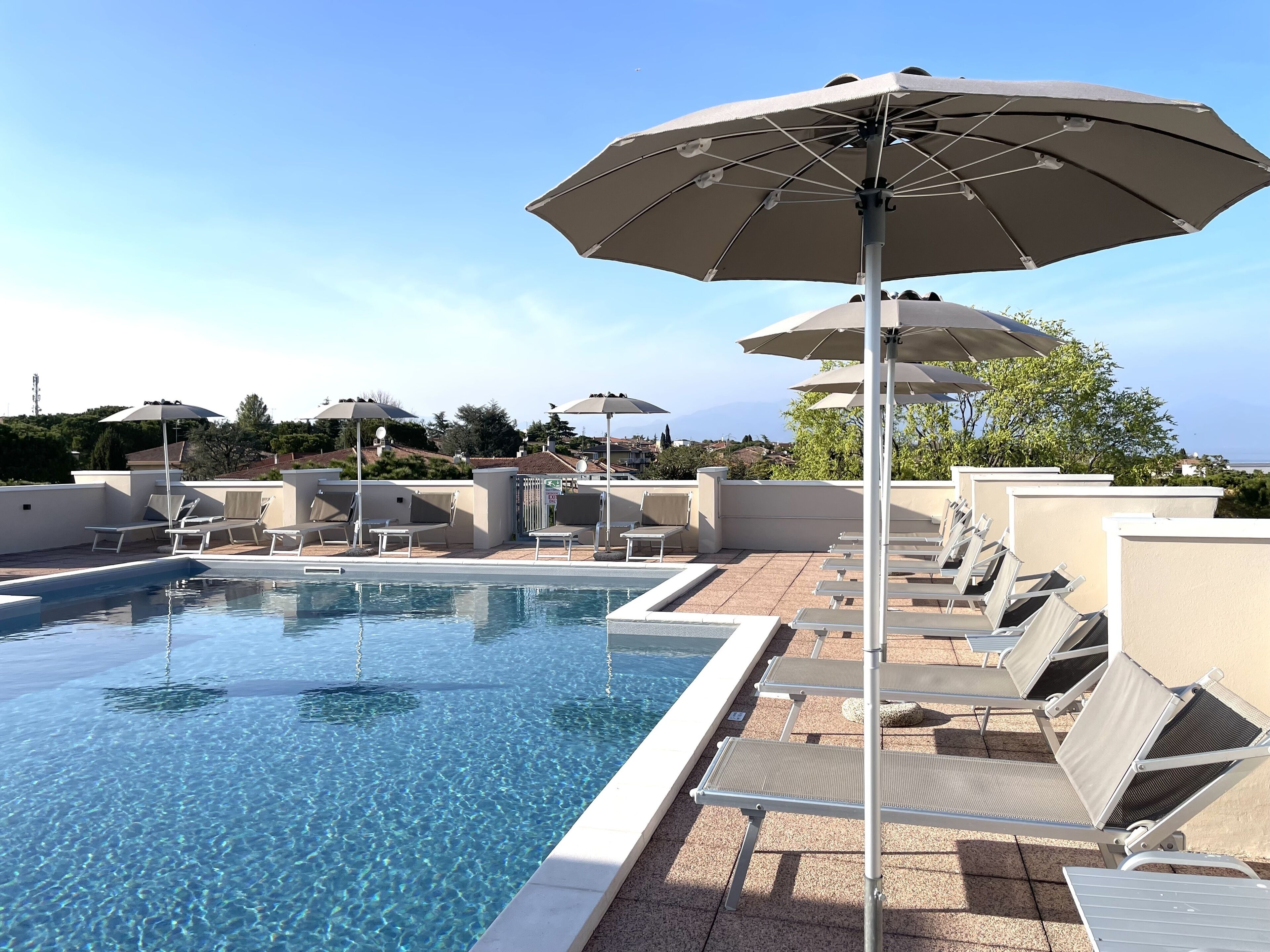 outdoor pool, a rooftop pool, pool loungers