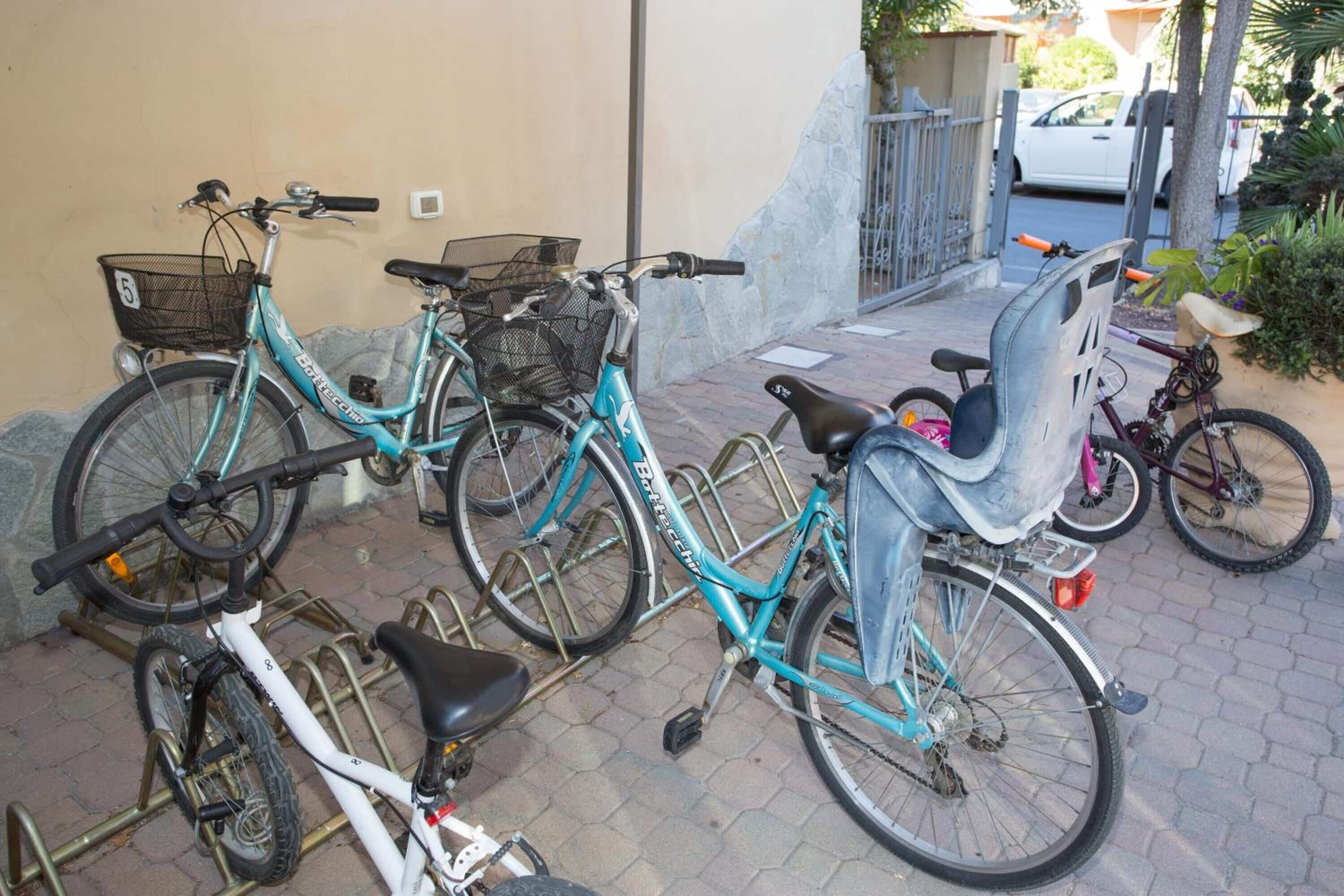 A bicycle rack with multiple bicycles parked.